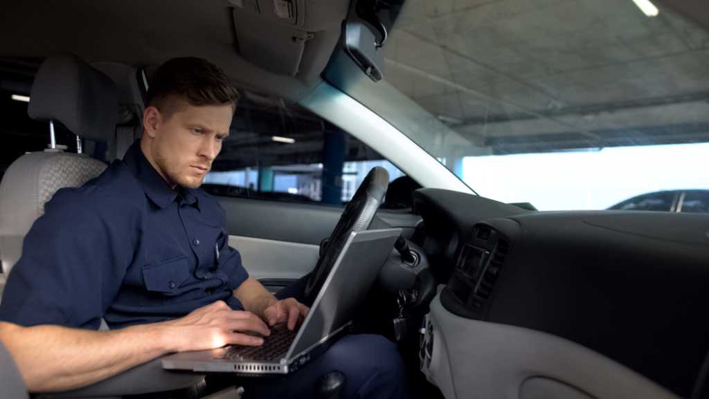 Police officer working on laptop